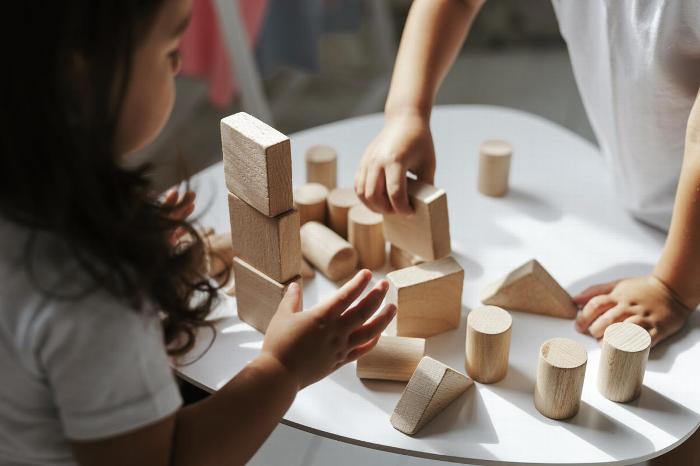 Child playing with wooden building blocks